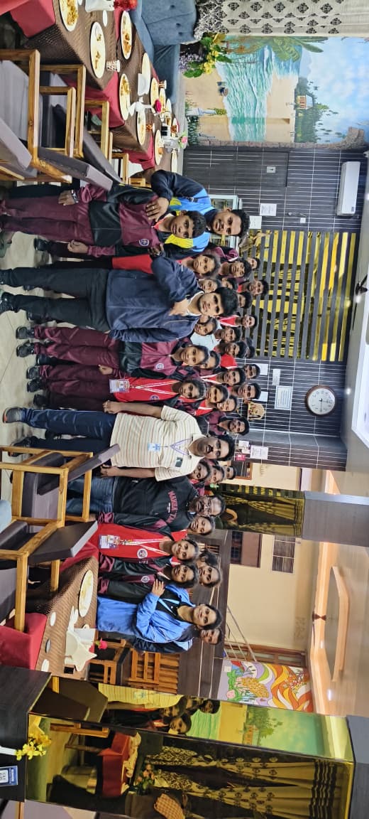 EMRS Ananthagiri students and staff in team tracksuits gathered together during a sports meet tour